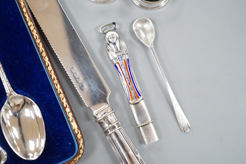 A cased set of six silver teaspoons, a silver bread knife, two 925 pill boxes, an 800 and enamel 'Tutankhamun' pencil case and a silver condiment spoon.